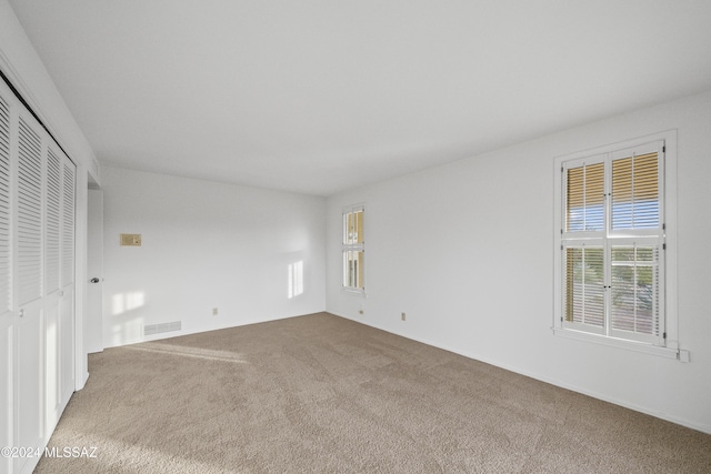 unfurnished bedroom featuring carpet flooring and a closet