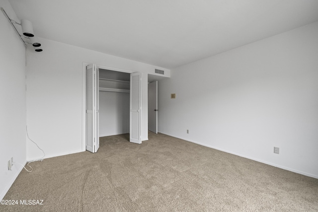 unfurnished bedroom with light colored carpet