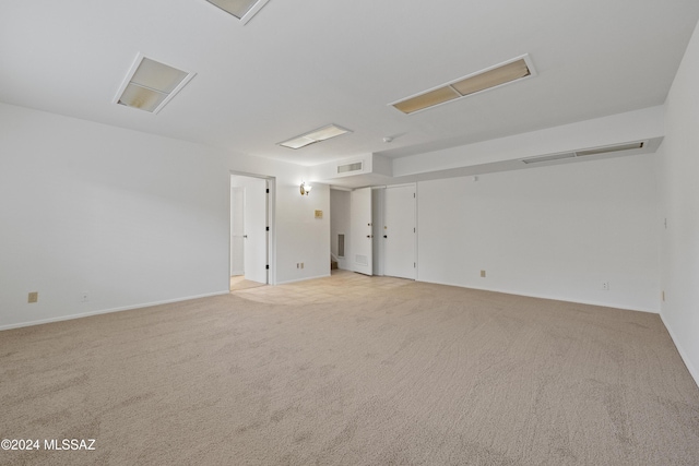 unfurnished room featuring light carpet