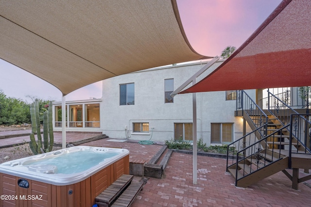 patio terrace at dusk with a hot tub