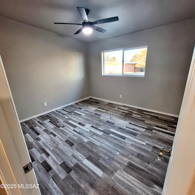 empty room with ceiling fan and dark hardwood / wood-style floors