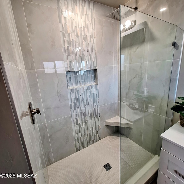 bathroom featuring vanity and a tile shower