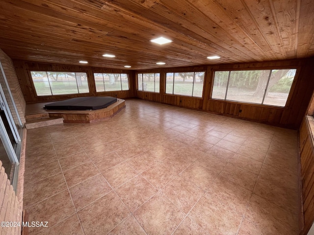 interior space with a jacuzzi, wooden ceiling, and a healthy amount of sunlight