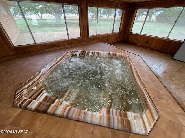 unfurnished sunroom featuring a hot tub