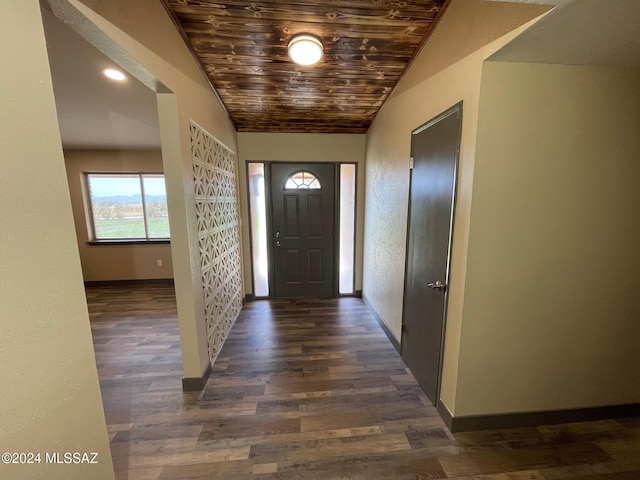 entryway with dark wood-type flooring, wooden ceiling, and vaulted ceiling