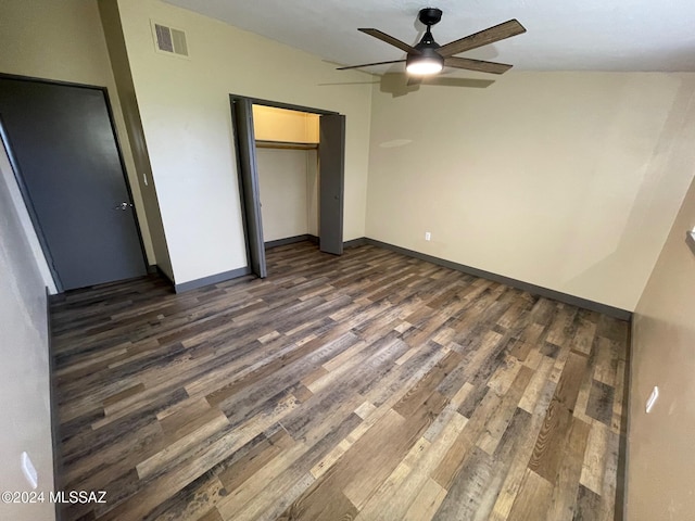 unfurnished bedroom featuring vaulted ceiling, ceiling fan, a closet, and dark hardwood / wood-style floors