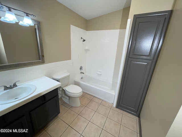 full bathroom featuring washtub / shower combination, vanity, toilet, and tile patterned flooring