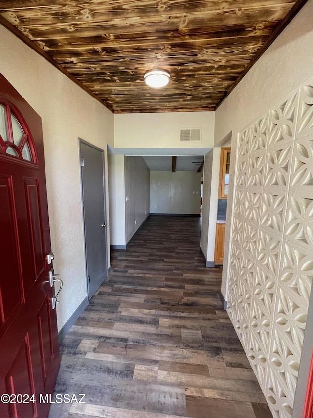 hall with dark hardwood / wood-style floors and wooden ceiling