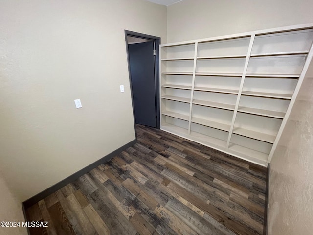 unfurnished room with dark hardwood / wood-style flooring