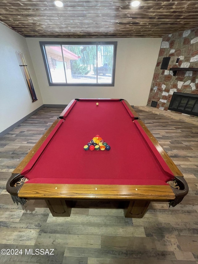 game room featuring a fireplace, dark wood-type flooring, and pool table