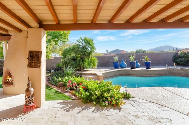 view of pool with a mountain view and a patio