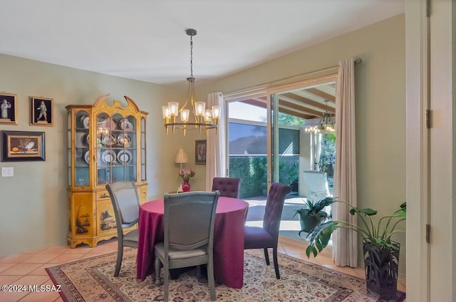 tiled dining space featuring a chandelier