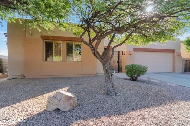 pueblo-style house featuring a garage