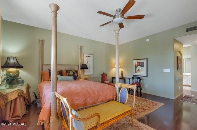 bedroom with ensuite bath, ceiling fan, and dark hardwood / wood-style floors