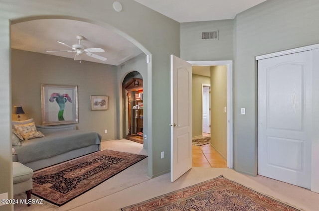 sitting room with ceiling fan and light tile patterned flooring