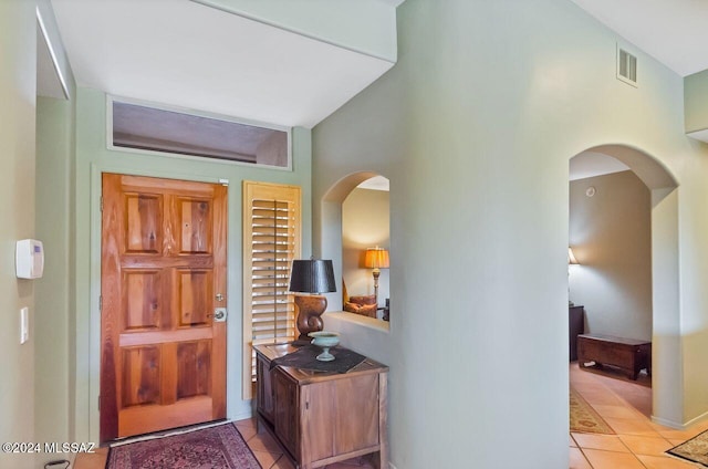 tiled entrance foyer with vaulted ceiling