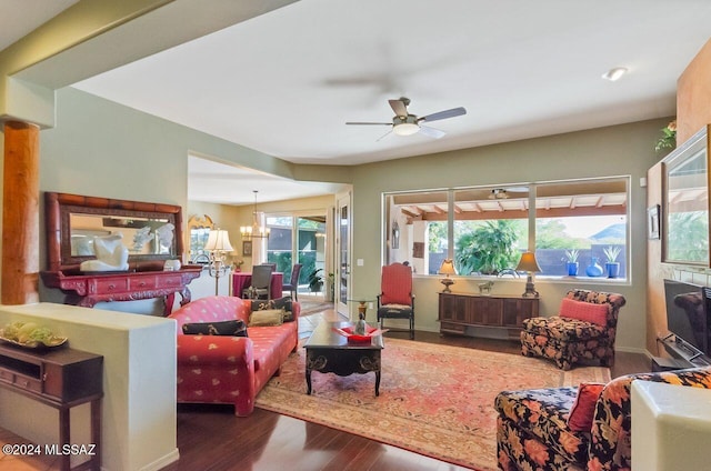 living room with ceiling fan with notable chandelier and wood-type flooring