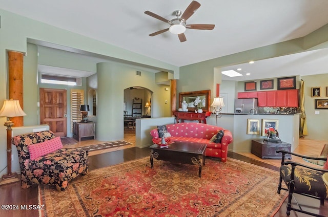 living room featuring ceiling fan and light wood-type flooring