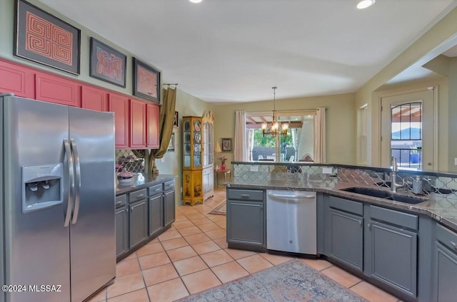 kitchen featuring a notable chandelier, plenty of natural light, sink, and appliances with stainless steel finishes