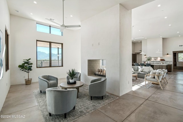 living room featuring a high ceiling and ceiling fan