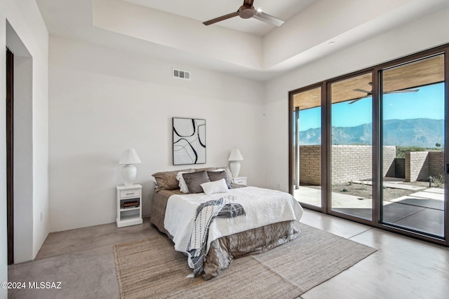 bedroom featuring access to outside, a mountain view, and ceiling fan