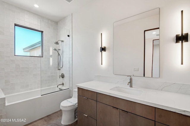 full bathroom featuring vanity, toilet, and tiled shower / bath