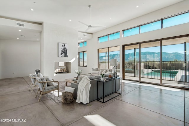 living room featuring a mountain view and ceiling fan