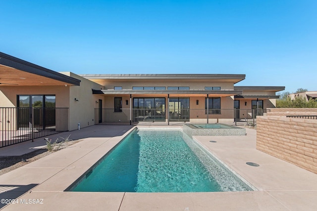 view of swimming pool with an in ground hot tub and a patio