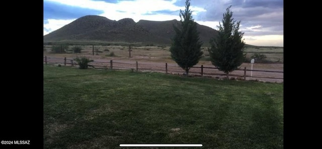 view of yard with a mountain view and a rural view