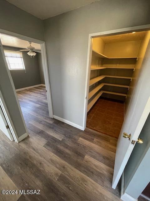 corridor featuring dark hardwood / wood-style flooring