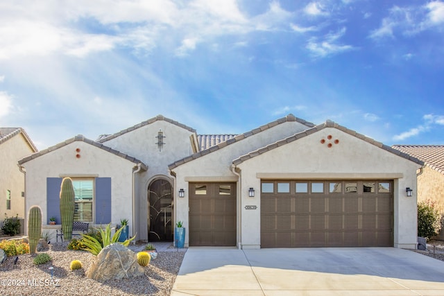 mediterranean / spanish-style house with a garage