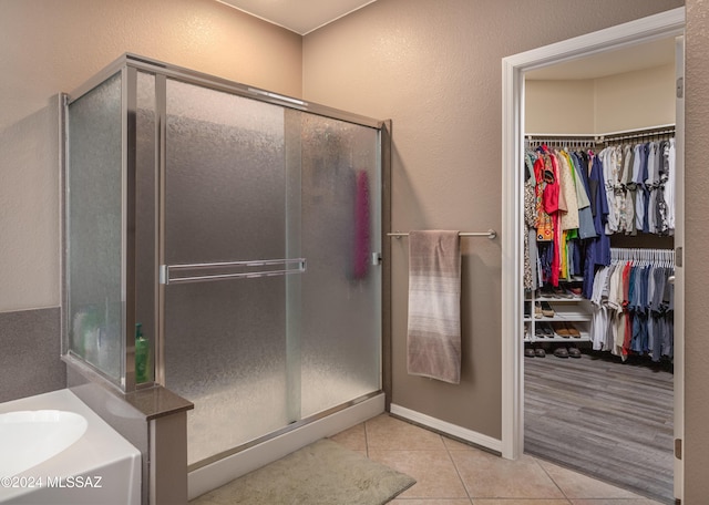 bathroom with sink, shower with separate bathtub, and hardwood / wood-style flooring