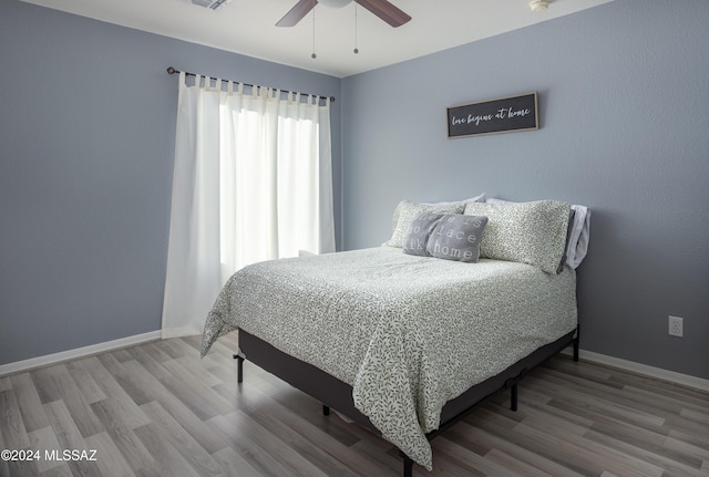 bedroom featuring ceiling fan and wood-type flooring