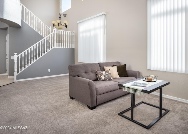 living room featuring carpet flooring and an inviting chandelier