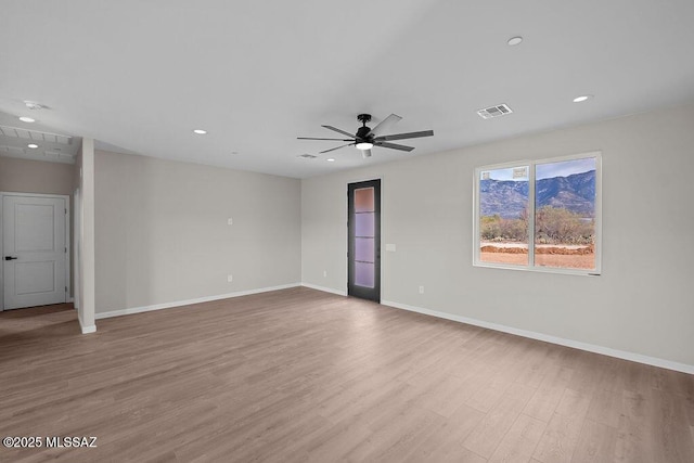 spare room featuring ceiling fan and light hardwood / wood-style floors