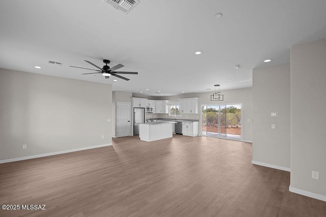 unfurnished living room with light hardwood / wood-style flooring and ceiling fan