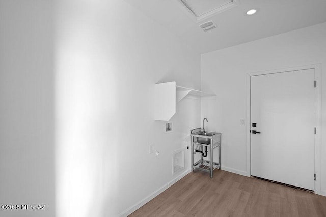 clothes washing area featuring washer hookup and light wood-type flooring