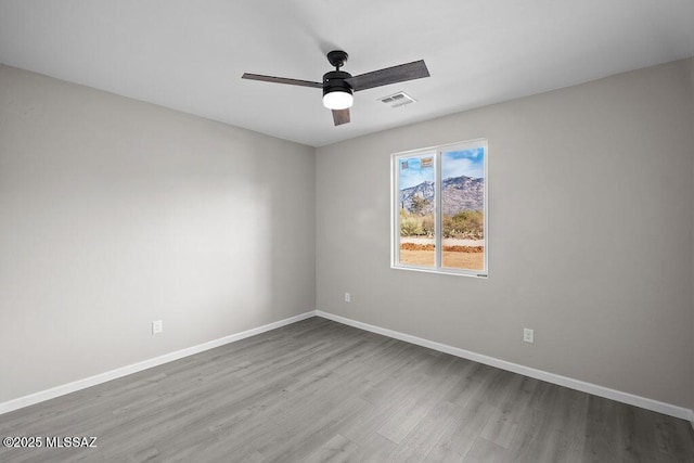 empty room with light hardwood / wood-style floors and ceiling fan