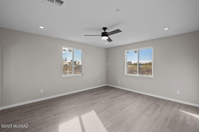 spare room featuring ceiling fan and light wood-type flooring