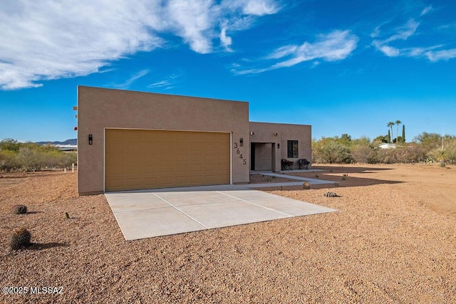 pueblo-style home with a garage