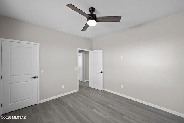 unfurnished bedroom featuring hardwood / wood-style flooring and ceiling fan