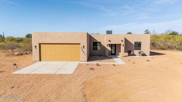 pueblo-style house with a garage