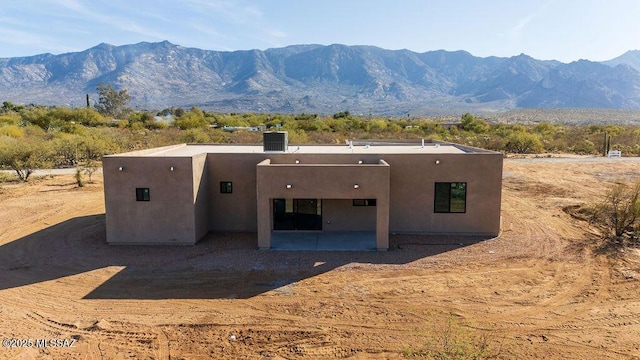 back of house featuring a patio area and a mountain view