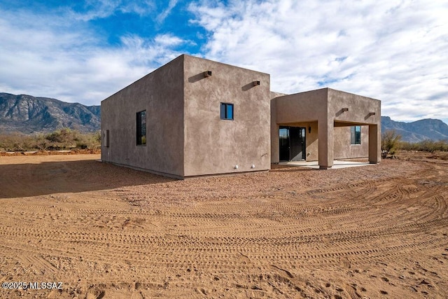 back of house with a mountain view