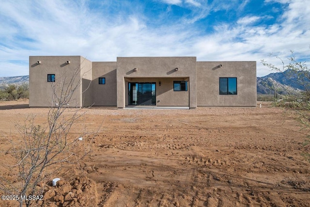 rear view of property with a mountain view