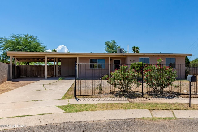 single story home featuring central AC and a carport