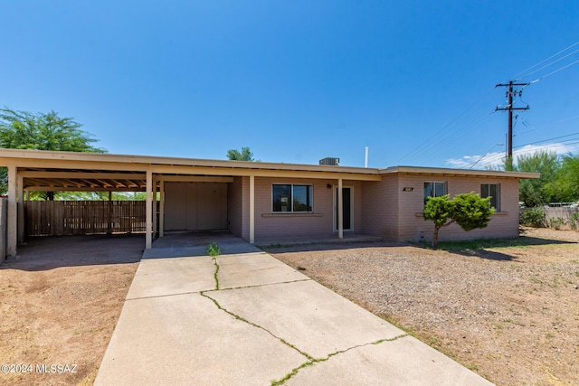 ranch-style home featuring a carport