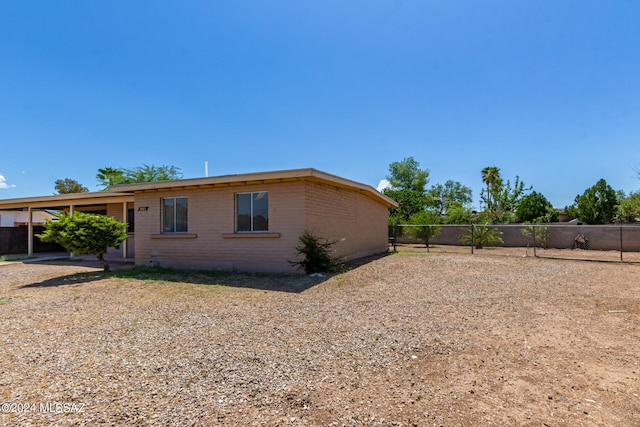 view of property exterior with a carport