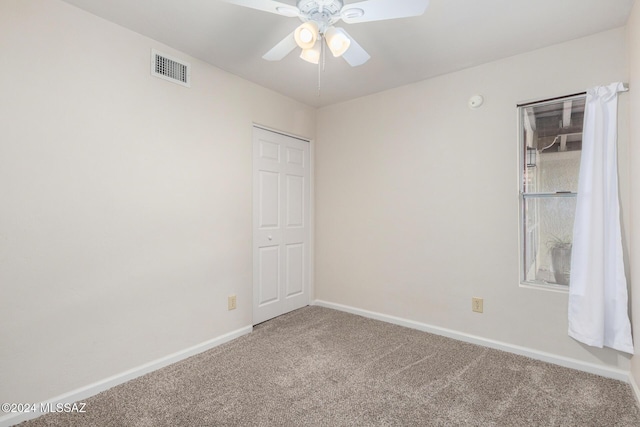 unfurnished room with carpet floors and ceiling fan