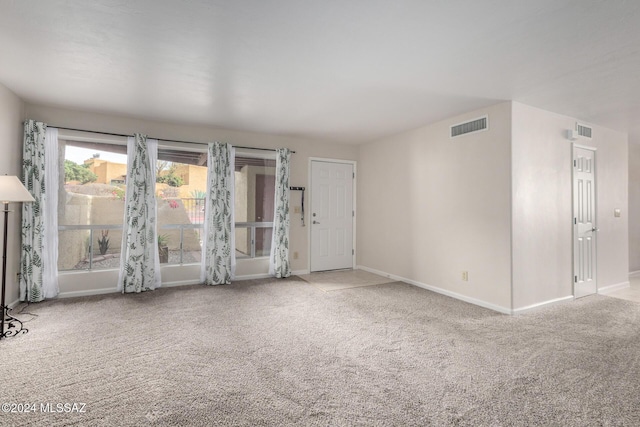 unfurnished room with light carpet